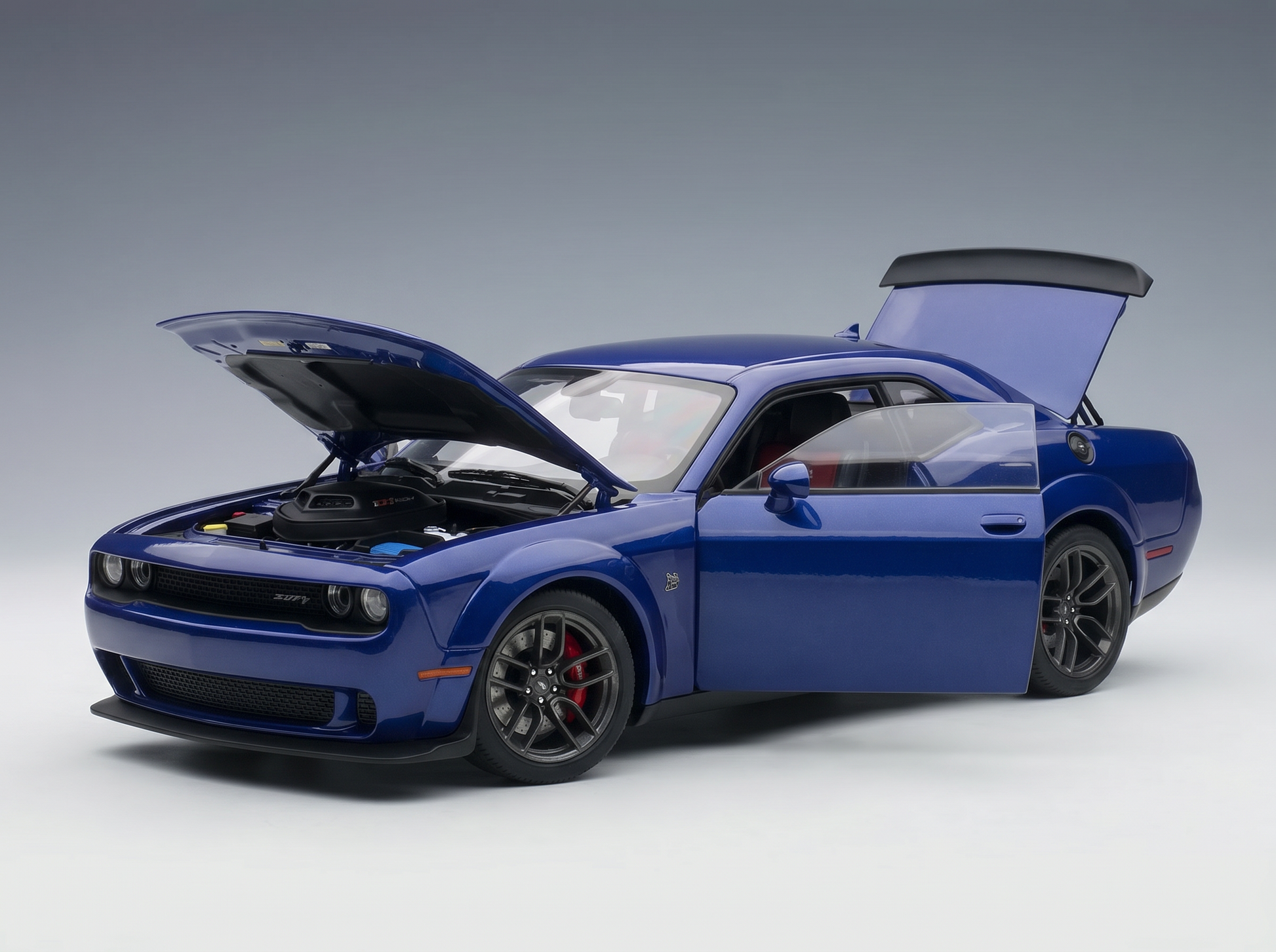 Blue scale model car with open hood and doors, showcased by Vroomi for collectors