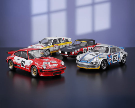 Four model racing cars on a reflective surface with a blue gradient background
