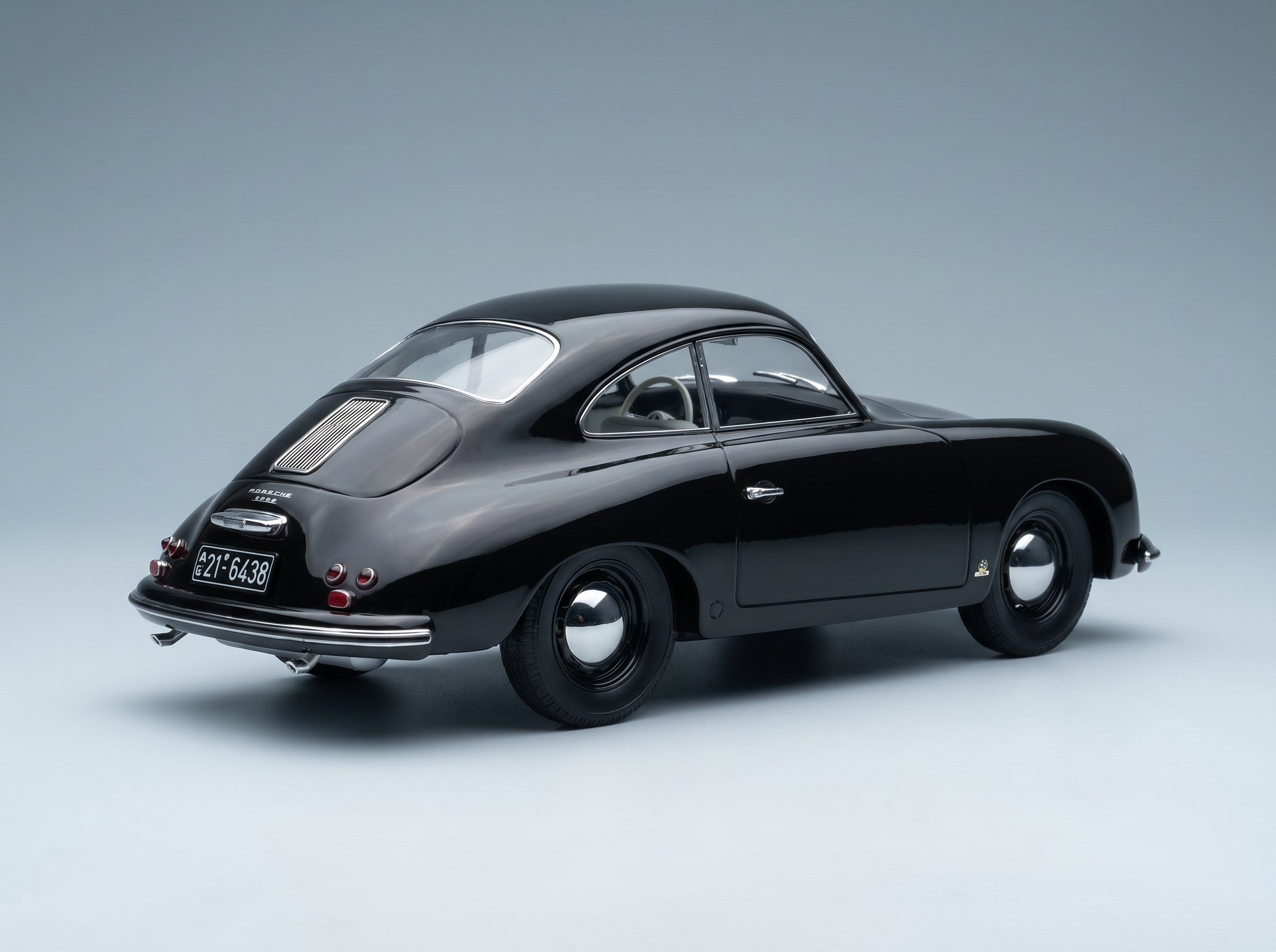 Black Porsche 356 scale model car from Vroomi, showcasing classic curves and chrome details.