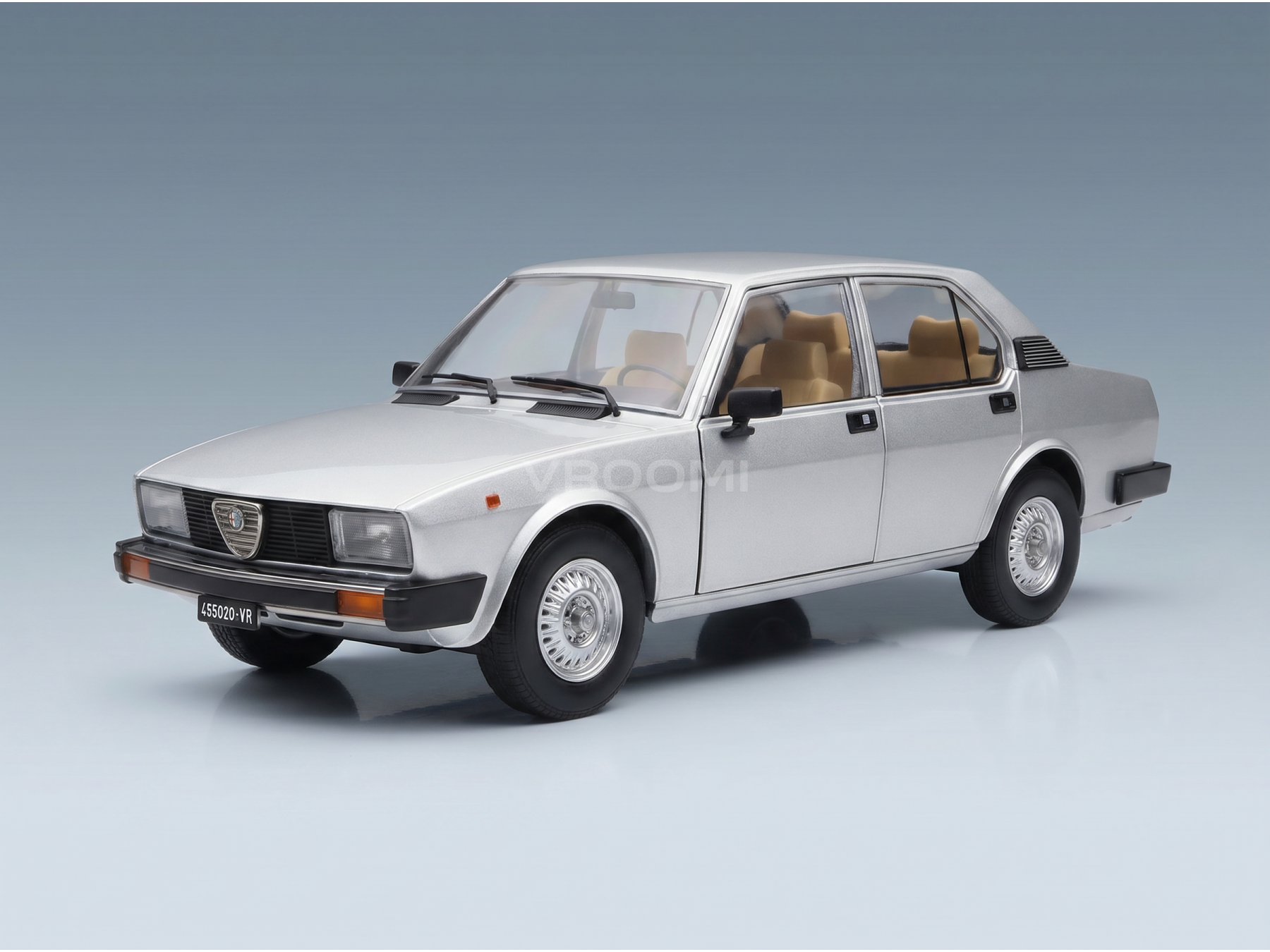 Zilverkleurig schaalmodel van een auto met een beige interieur, gepresenteerd door Vroomi voor verzamelaars.