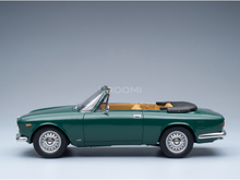 Green convertible scale model car with tan interior, showcased by Vroomi for collectors