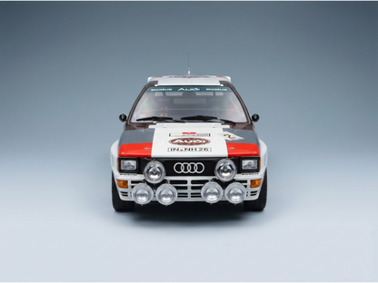 Front view of a detailed Audi Quattro rally scale model car with Michelin and Bosch decals, showcased by Vroomi.