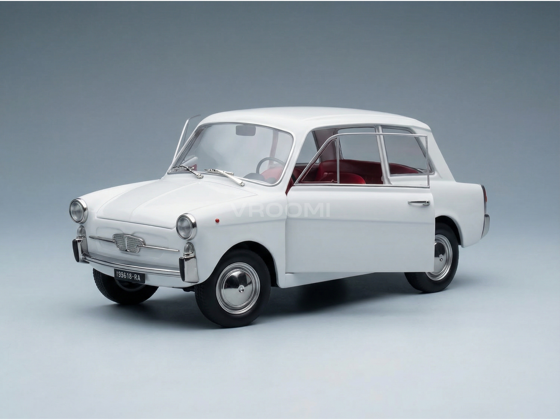 Coche clásico a escala de los años 60, de color blanco y con el interior rojo, presentado por Vroomi para coleccionistas