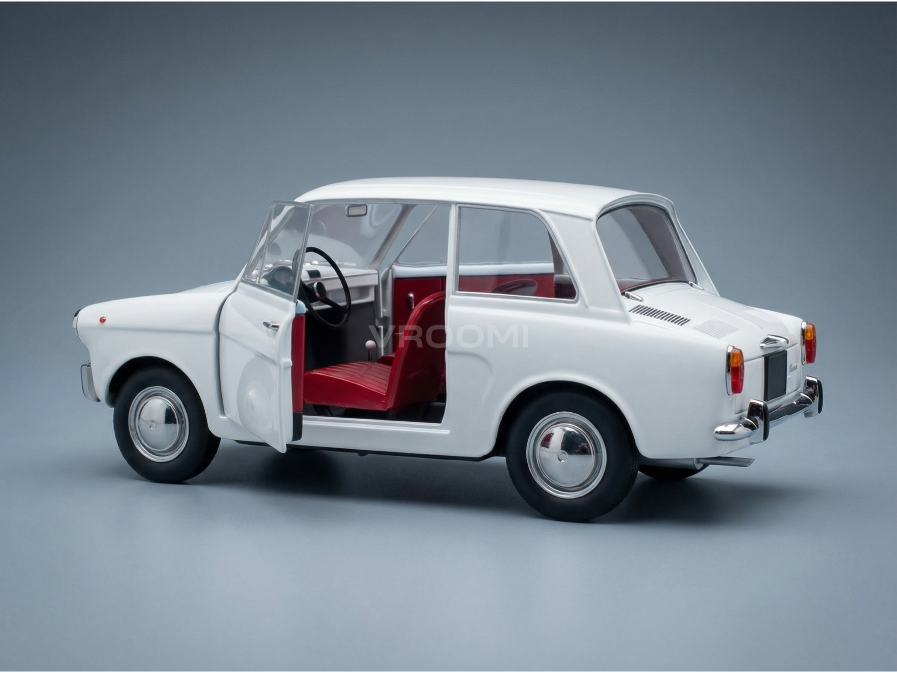 Maqueta de coche en color blanco con interior rojo, puertas que se abren, expuesta por Vroomi para coleccionistas