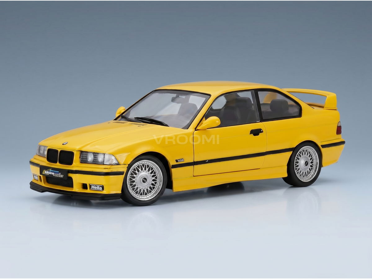 Yellow BMW M3 E36 scale model car by Vroomi, featuring detailed rims and racing decals on a studio background.