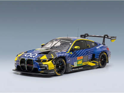 Blue and yellow BMW M4 GT3 scale model car with racing decals, displayed by Vroomi for collectors.