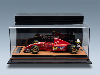 Red Ferrari scale model car in display case, featuring Goodyear tires and Agip branding, curated by Vroomi