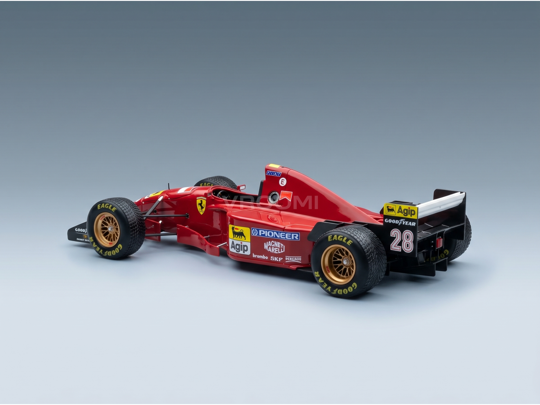 Red Ferrari scale model car with Agip and Goodyear branding, showcased by Vroomi for collectors.