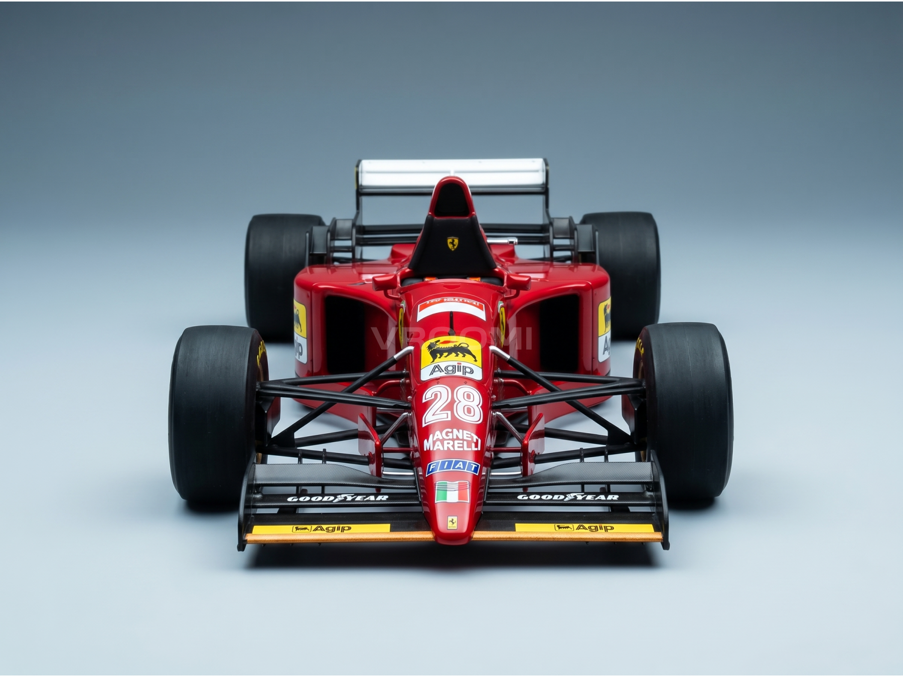 Red Ferrari scale model car with Agip and Goodyear branding, showcased by Vroomi