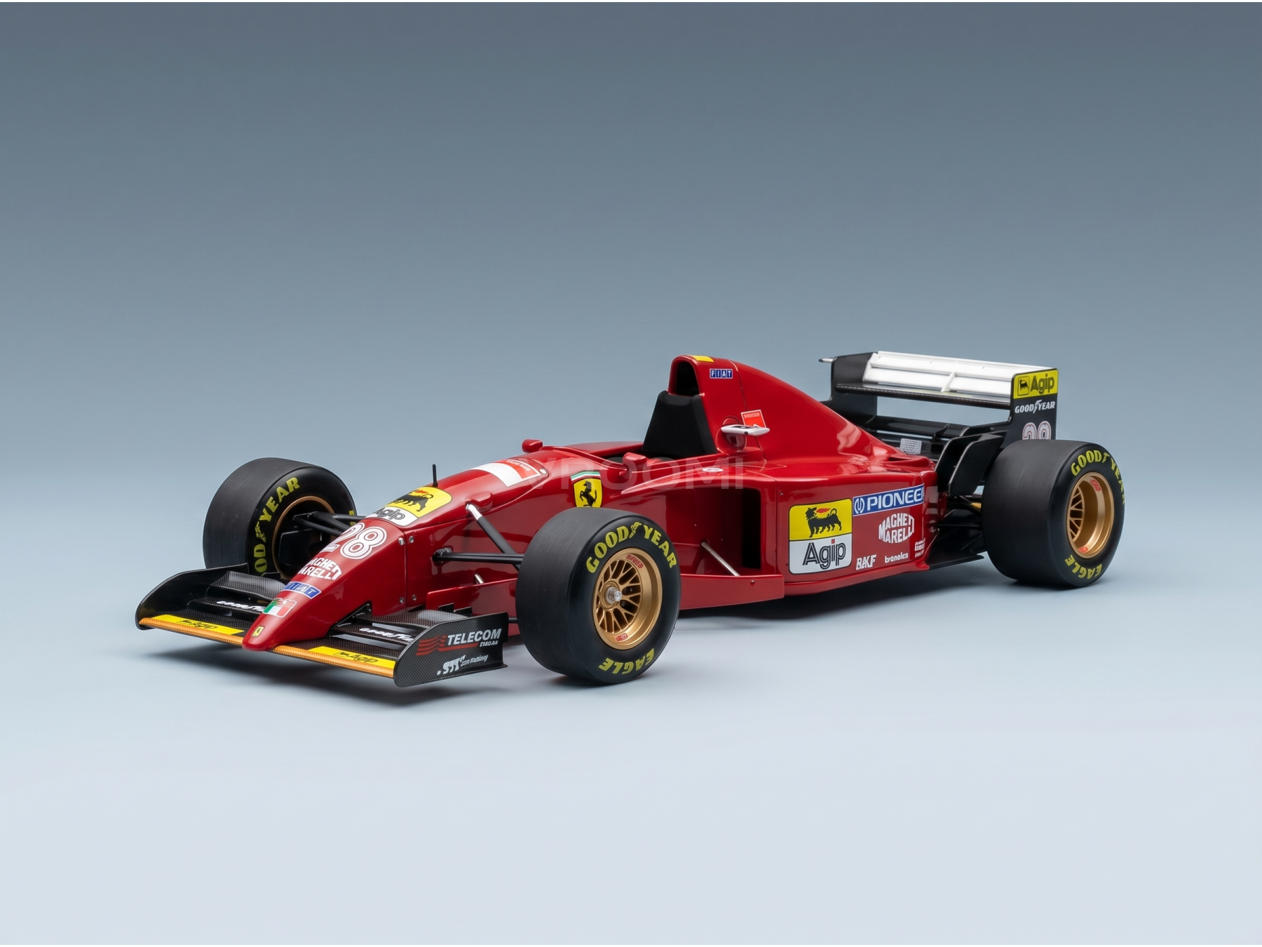 Red Ferrari scale model car with Goodyear tires, showcased by Vroomi for collectors.