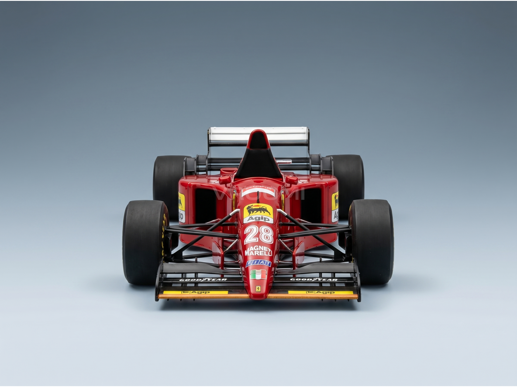 Red Ferrari F1 scale model car with Agip & Goodyear logos, displayed at Vroomi for collectors