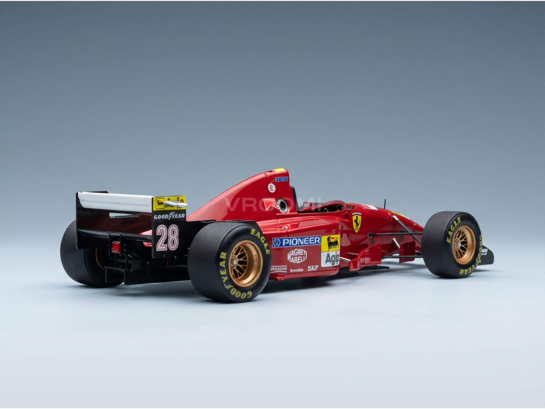 Red Ferrari scale model car with Goodyear tires, number 28, showcased at Vroomi for collectors.