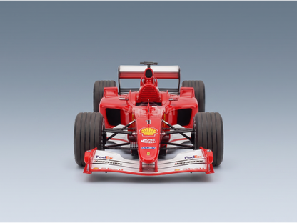 Red Ferrari F1 scale model car with Shell, FedEx, Bridgestone logos, Vroomi collection