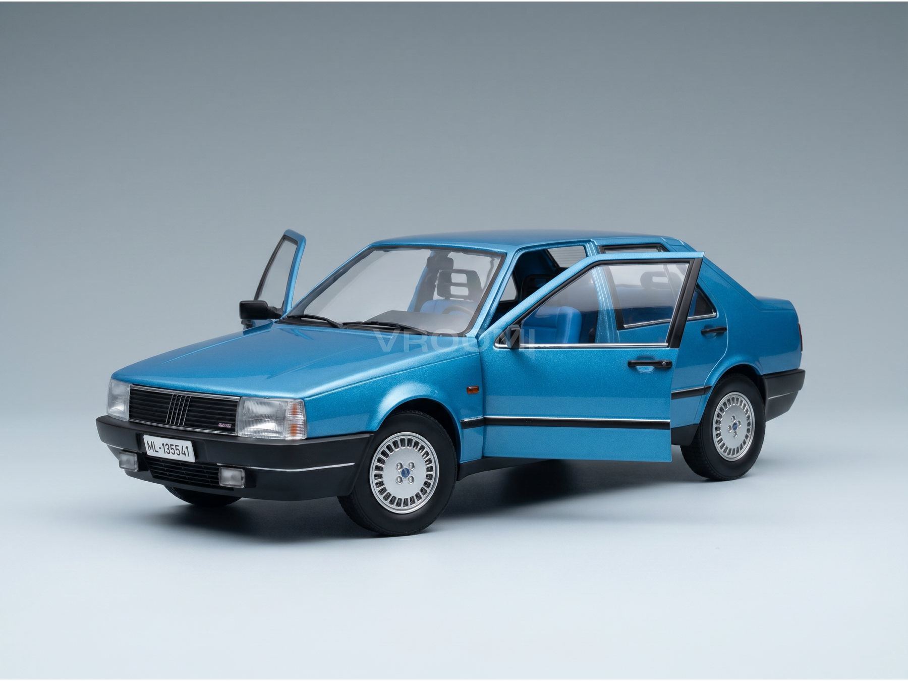 Blue scale model car with open doors, detailed interior and wheels, showcased by Vroomi for collectors.