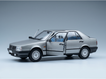 Silver scale model car with open doors, detailed interior, at Vroomi
