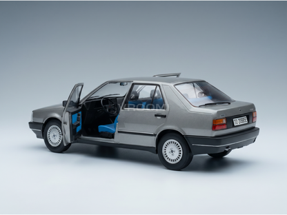 Silver scale model car with open doors, blue interior, detailed wheels — Vroomi collector's replica