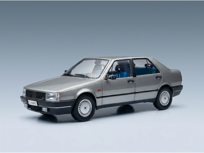 Silver scale model car with blue interior, showcased by Vroomi for collectors.