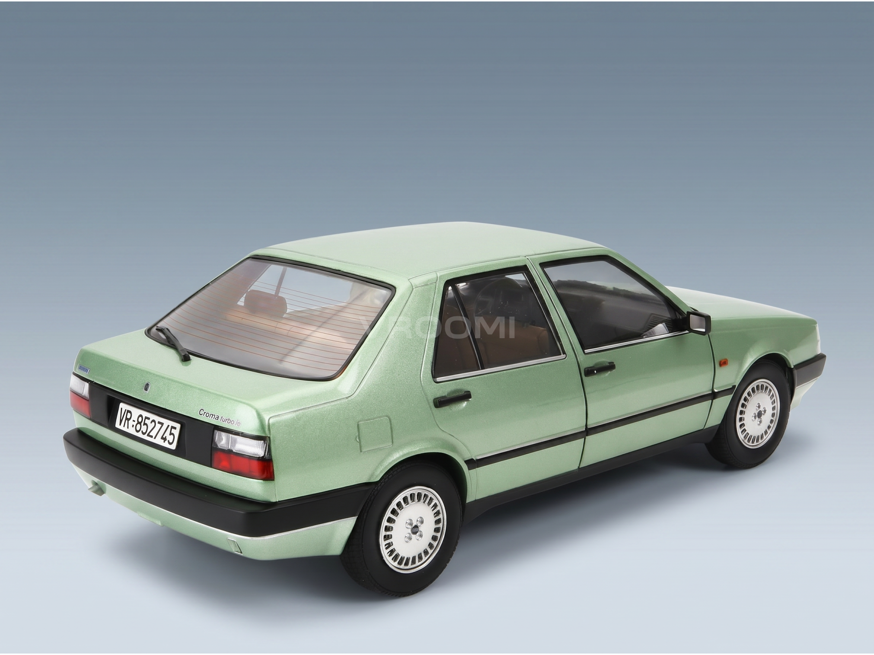 Green Lancia Croma Turbo IE scale model car from Vroomi, detailed die-cast replica with white wheels and black trim