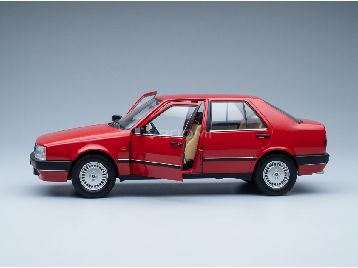 Red scale model car with open doors, detailed interior, showcased by Vroomi for collectors