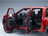 Voiture miniature rouge avec portes ouvertes dévoilant un intérieur détaillé, disponible chez Vroomi