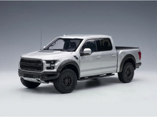 Maqueta a escala de un Ford Raptor plateado con llantas negras, presentada por Vroomi para coleccionistas.