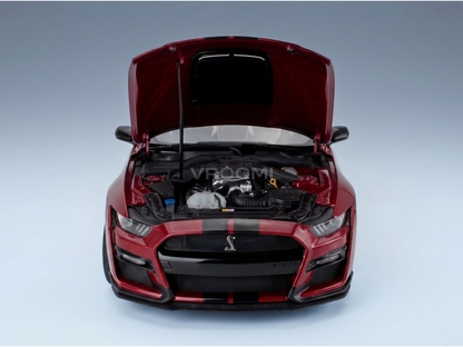 Red scale model car with open hood, detailed engine, and Vroomi branding for collectors.