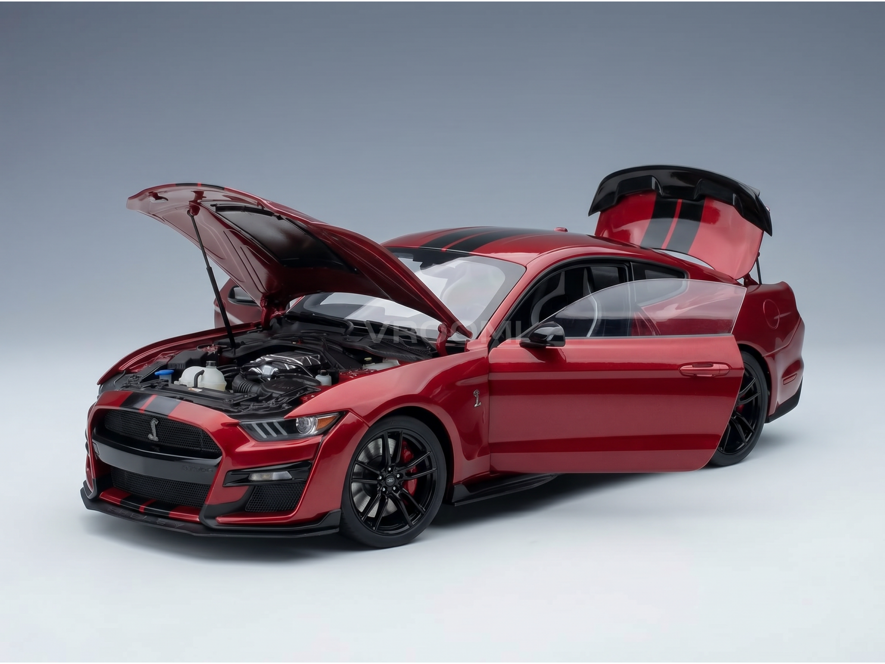 Red scale model car with open hood and trunk, detailed engine, Vroomi collector's replica