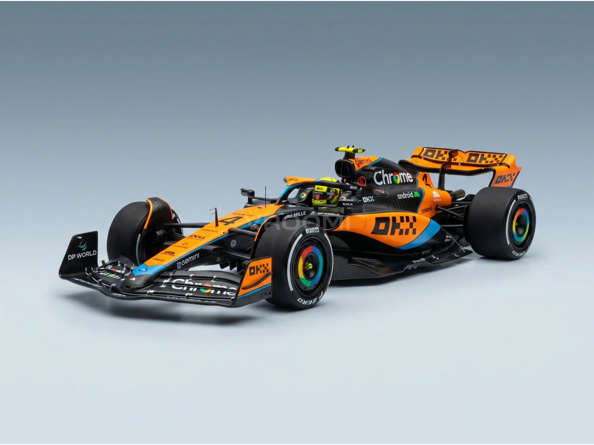 Orange and black Formula 1 scale model car with Chrome and DP World livery, showcased by Vroomi