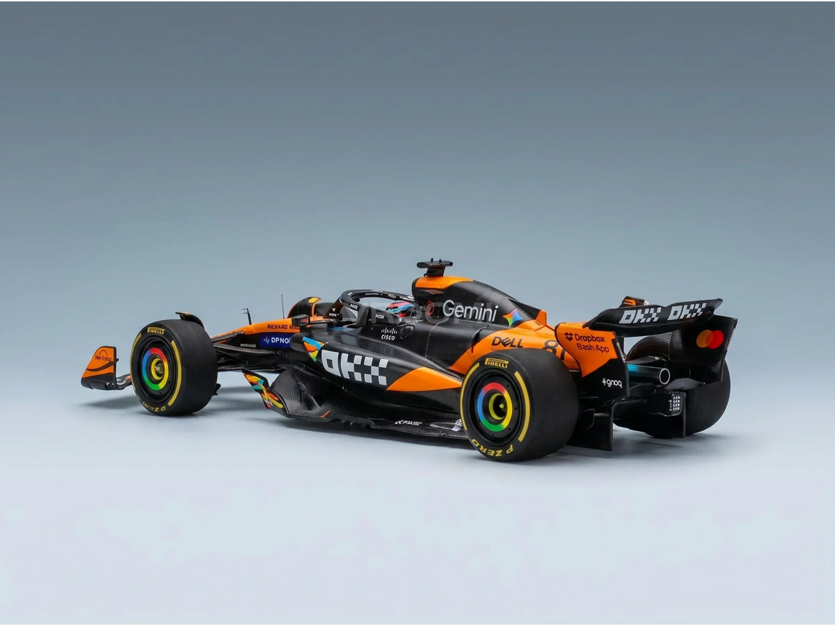 Orange and black Formula 1 scale model car with rainbow rims, featured at Vroomi for collectors.