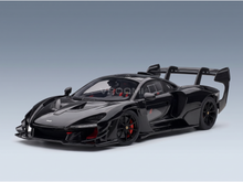 Black McLaren Senna scale model car with carbon fiber details and red accents, showcased by Vroomi