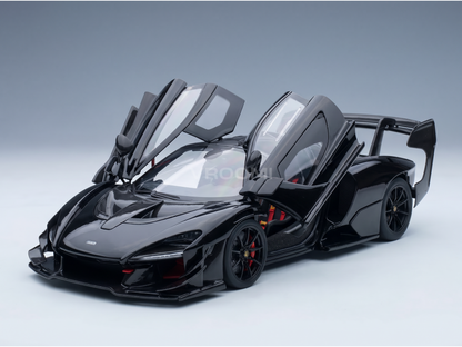 Black McLaren Senna scale model car with open doors, carbon fiber details, red accents — Vroomi