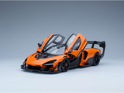 Orange scale model car with open doors, showcased by Vroomi for collectors and motorsport fans.