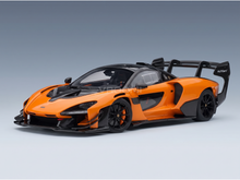 Orange McLaren Senna scale model car with carbon fiber details, showcased by Vroomi for collectors.