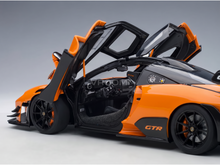 Orange and black GTR scale model car with open doors, detailed interior, from Vroomi