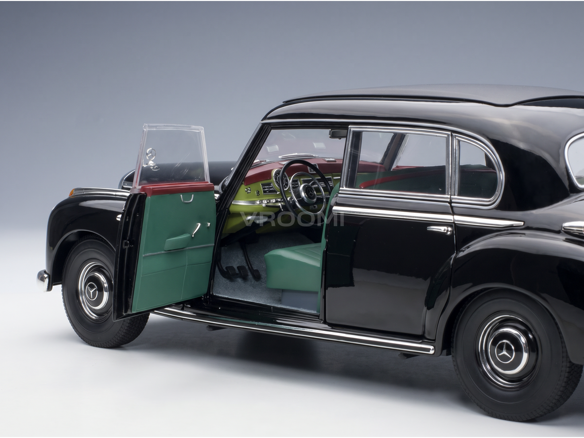 Black Mercedes-Benz scale model car with open doors, green interior, at Vroomi