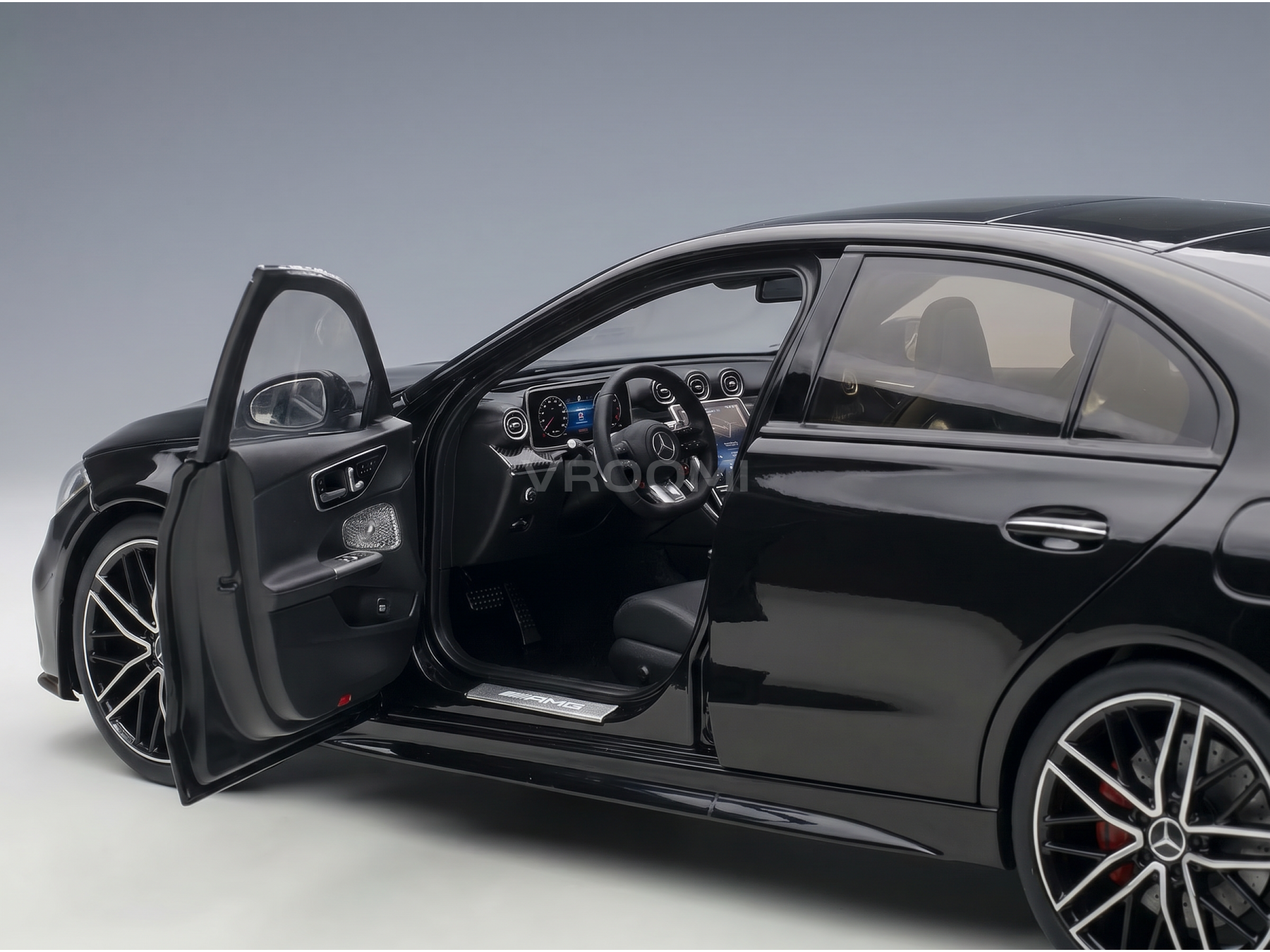 Black Mercedes-AMG scale model car with open door, detailed interior, at Vroomi