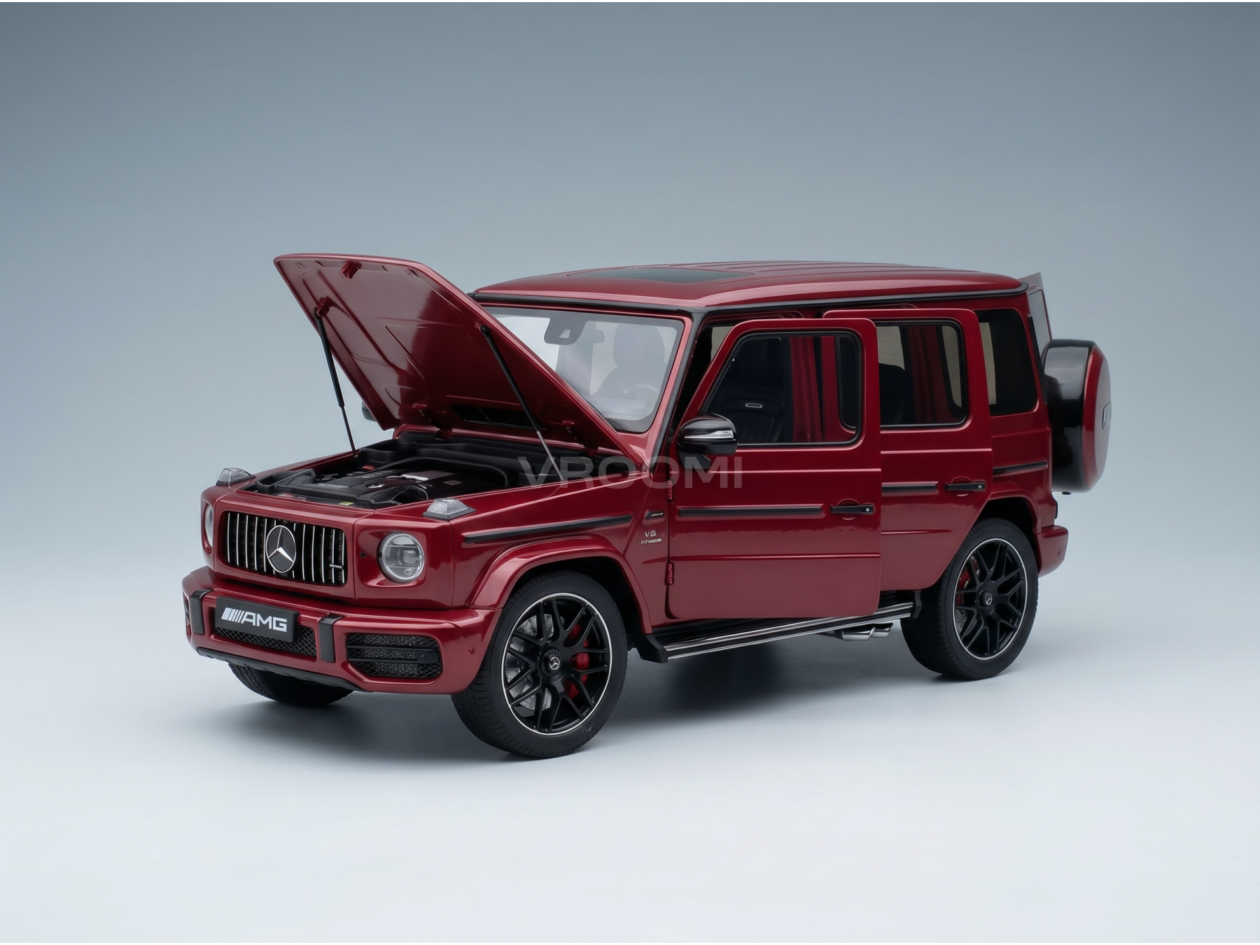 Red Mercedes-AMG G63 scale model car with open hood, showcased by Vroomi for collectors.