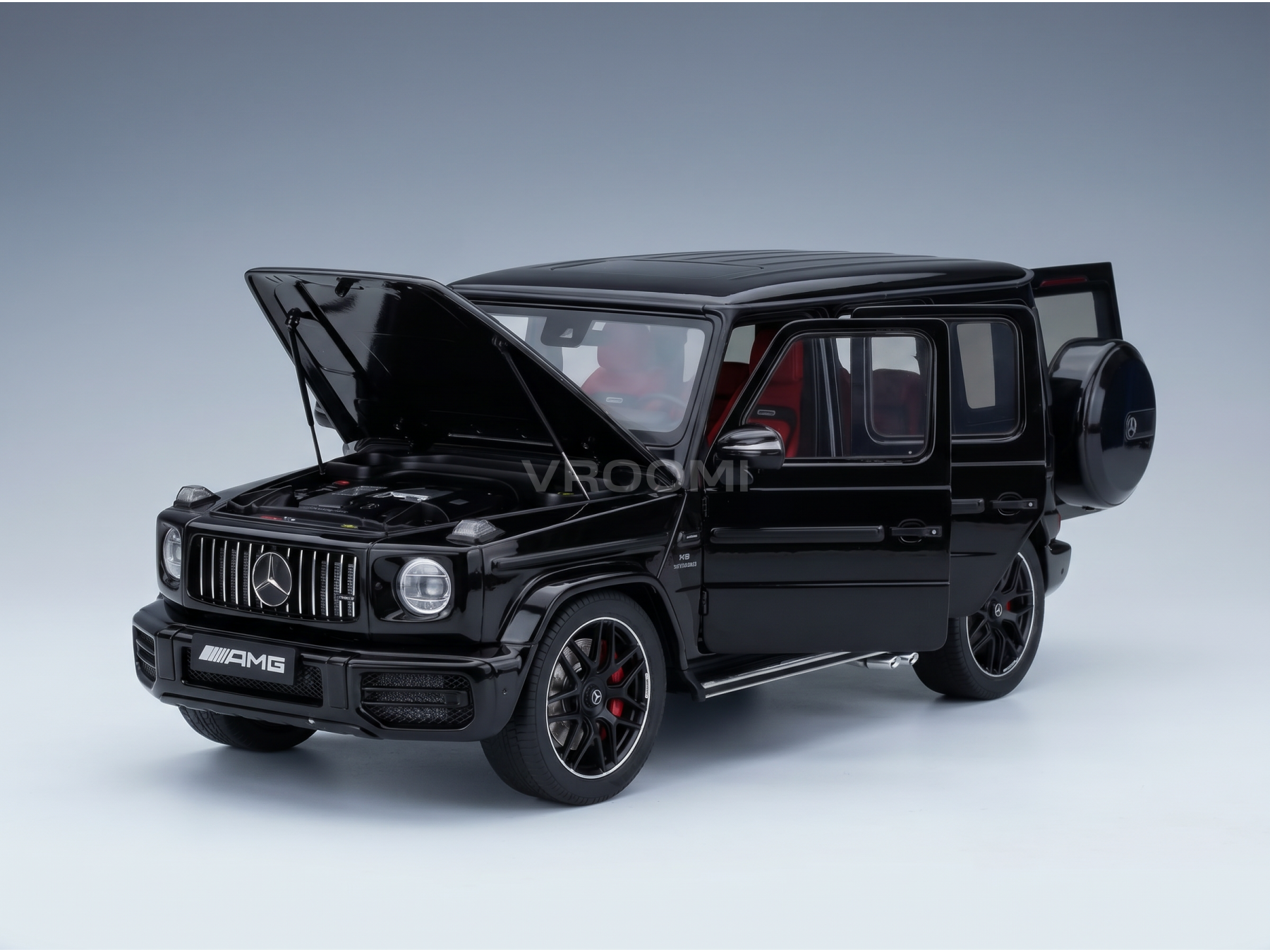 Black Mercedes-AMG G63 scale model car with open hood and doors, showcased by Vroomi