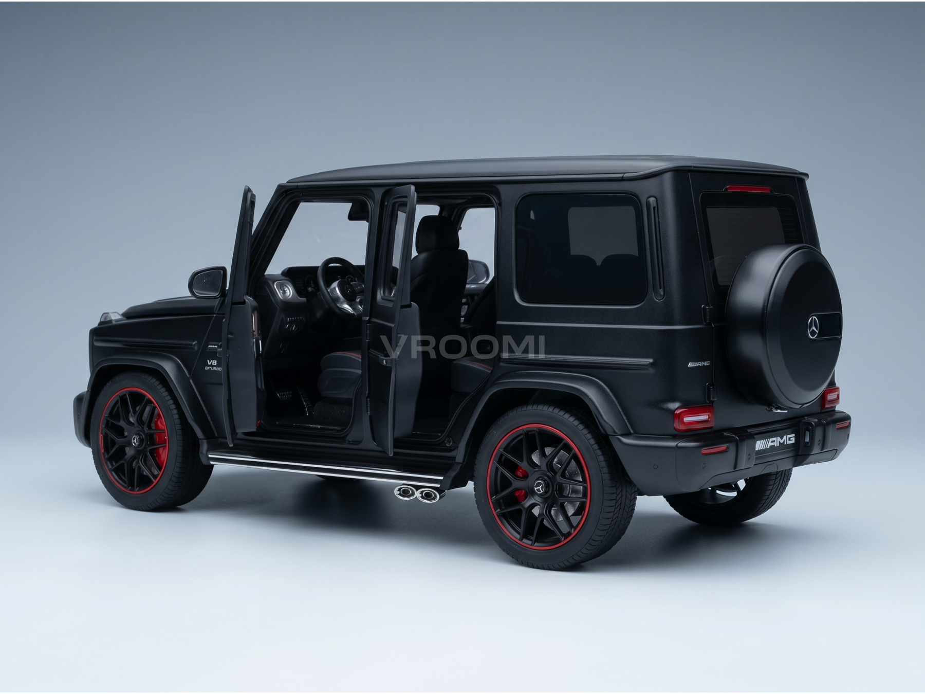 Black Mercedes-AMG G63 scale model car with open doors, red-rimmed wheels, and Vroomi branding
