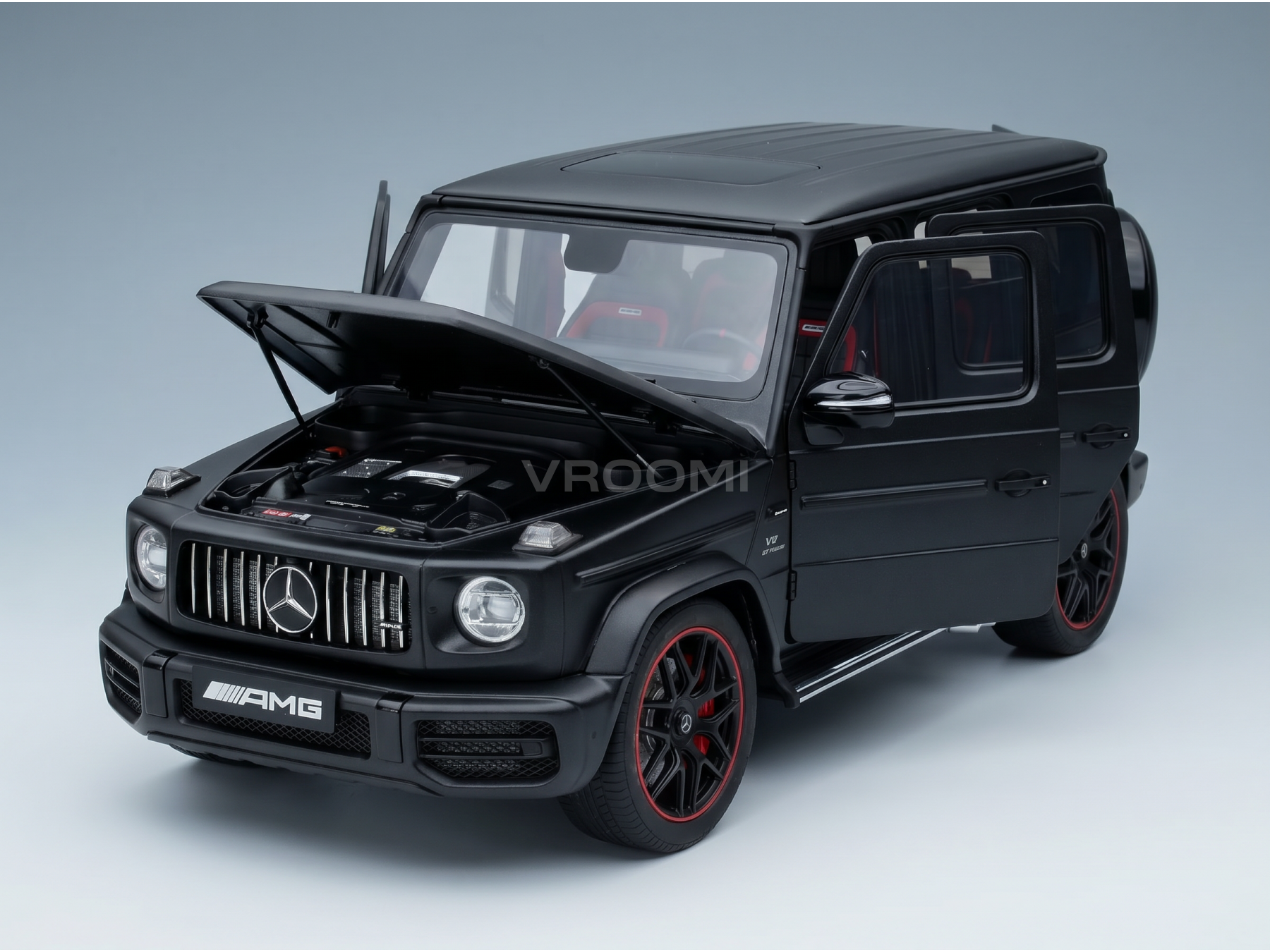 Black Mercedes-AMG G63 scale model car with open hood and doors, showcased by Vroomi
