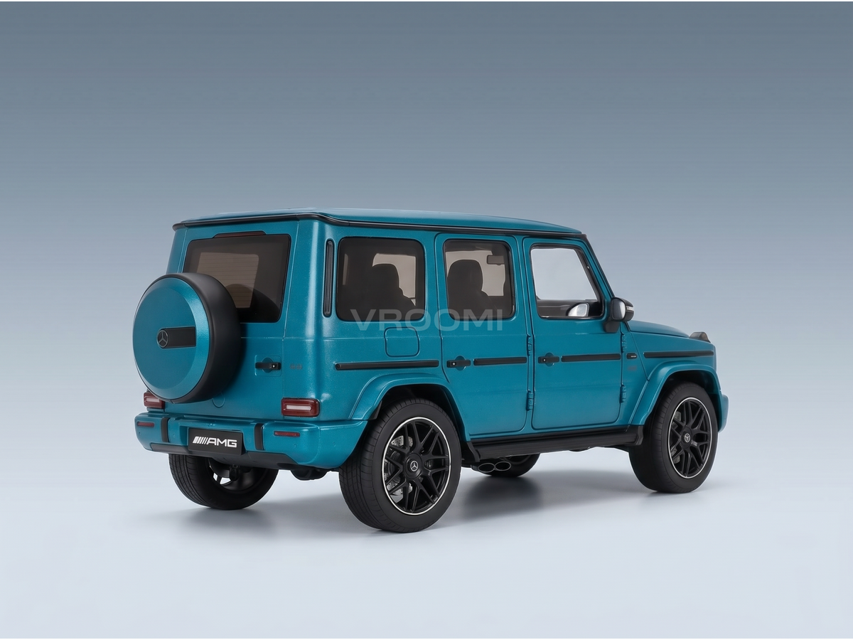 Teal Mercedes-AMG G63 scale model car from Vroomi, detailed die-cast replica with black wheels and rear spare tire.