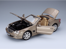Gold Mercedes-Benz SL500 scale model car with open doors, hood, and trunk, showcased by Vroomi