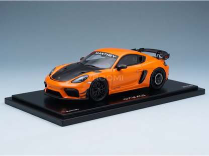 Orange Manthey GT4 RS scale model car on display base, featured by Vroomi for collectors