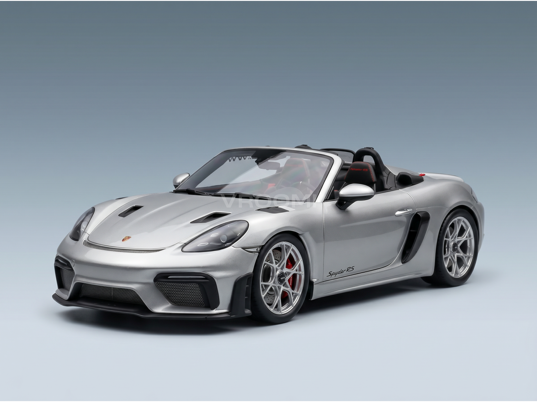 Silver Porsche Spyder RS scale model car from Vroomi, featuring sleek design and detailed wheels.