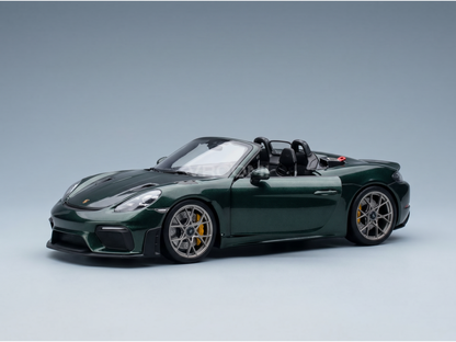 Green Porsche scale model car with yellow brakes, showcased by Vroomi for collectors