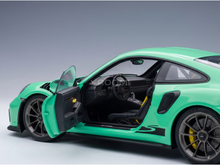 Green scale model car with open doors, detailed interior, and Vroomi branding