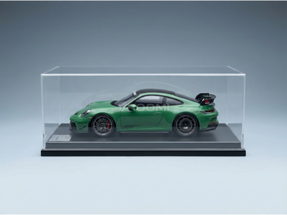 Green Porsche 911 GT3 RS scale model car in display case by Vroomi, featuring detailed wheels and rear wing.
