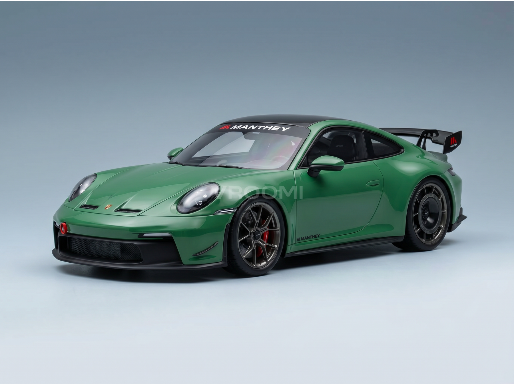 Green Manthey Porsche 911 GT3 RS scale model car from Vroomi, featuring black accents and racing decals.