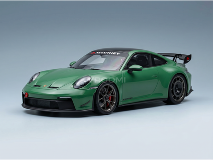 Green Manthey Porsche 911 GT3 RS scale model car from Vroomi, featuring black accents and racing decals.