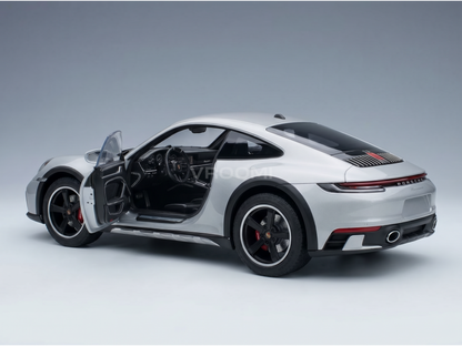 Silver Porsche scale model car with open door, detailed interior, at Vroomi